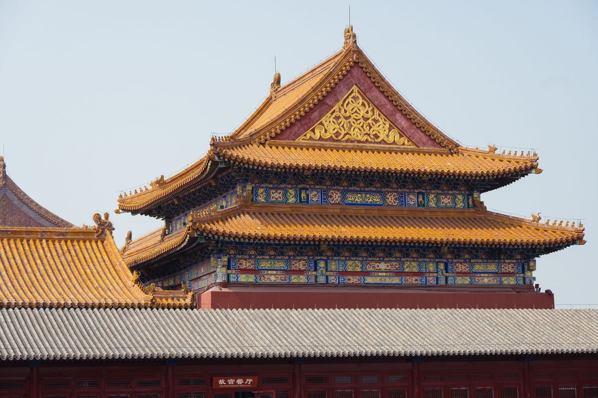 Golden tiled rooftops and ornate eaves of the Forbidden City in Beijing