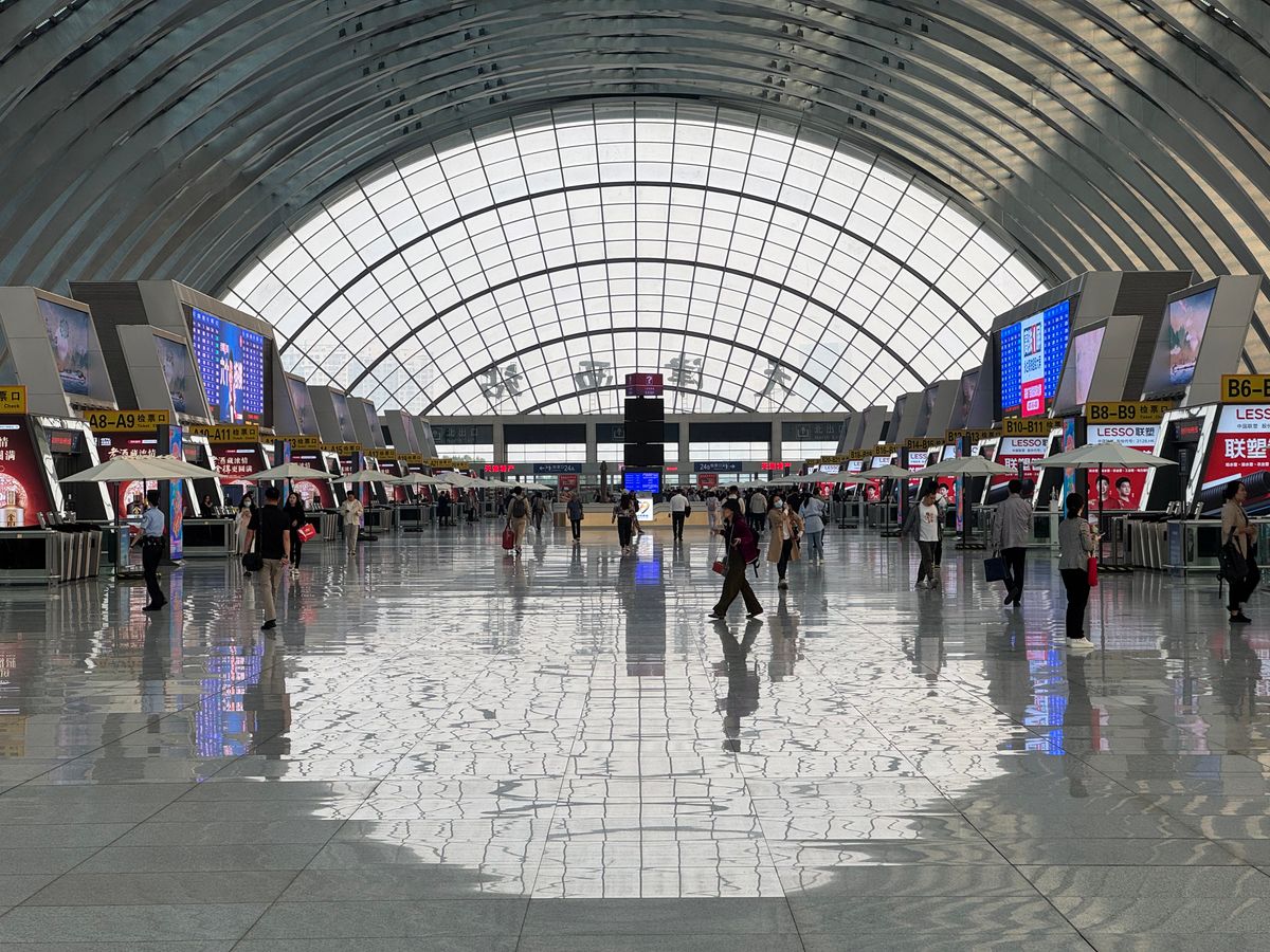 Travelers in a large modern transit hall in China