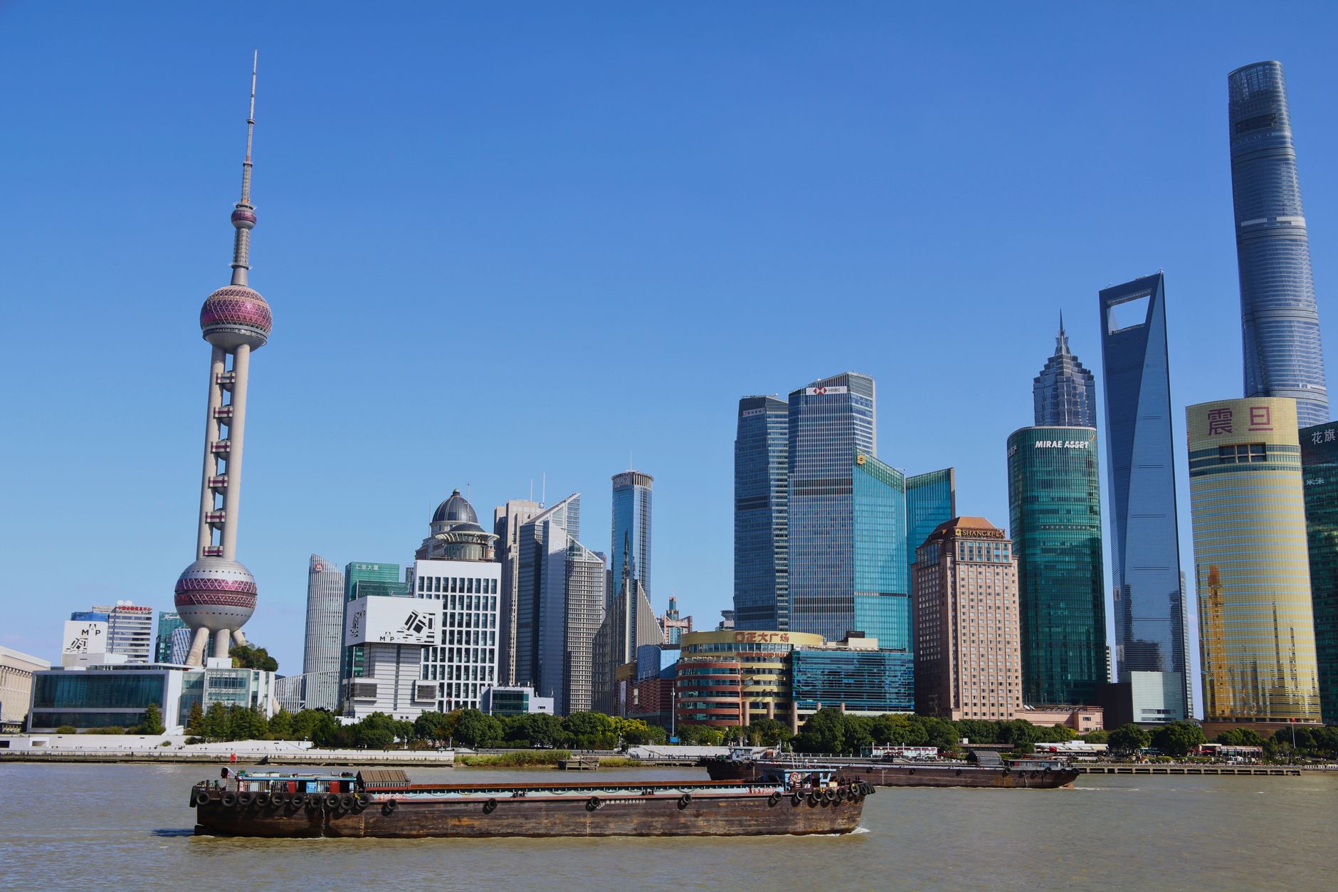 Shanghai's Pudong skyline with the Oriental Pearl Tower and Shanghai Tower seen across the Huangpu River