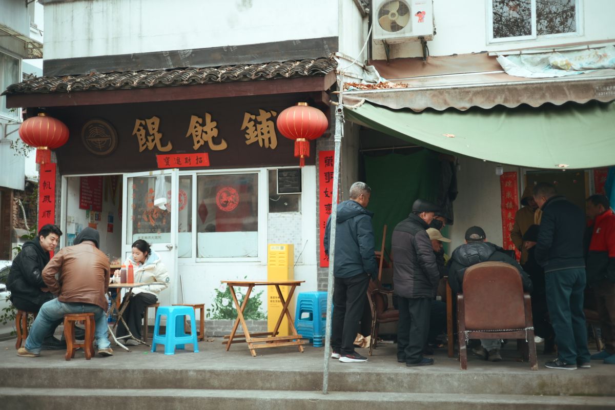 Friends sharing dishes around a table at a Chinese restaurant