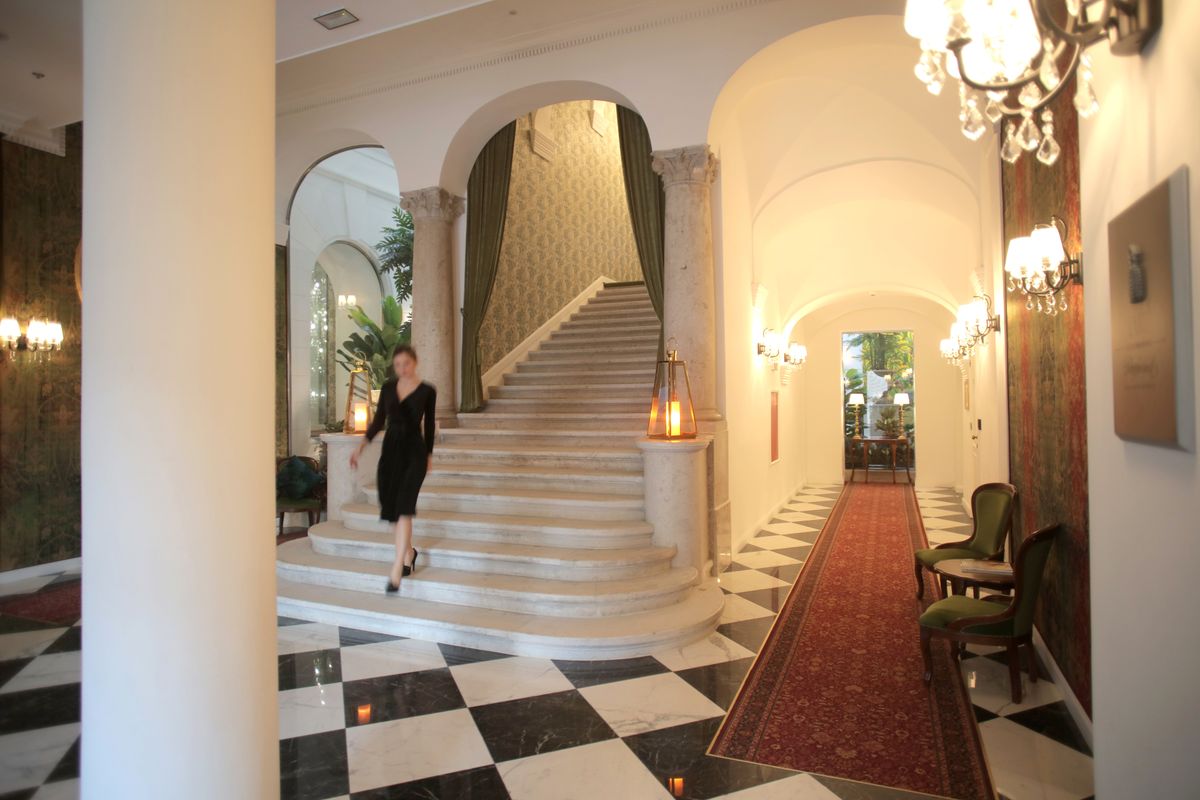 Guests at the reception desk of a hotel lobby