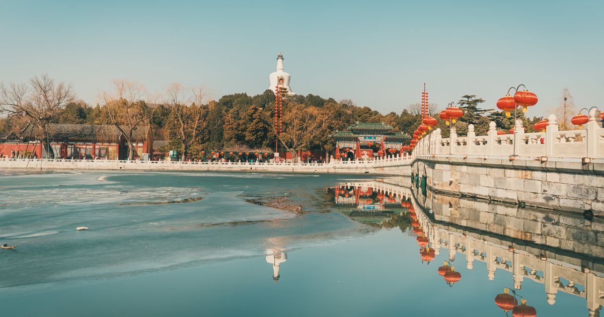 Winter view of the White Dagoba and red lanterns along the marble balustrade