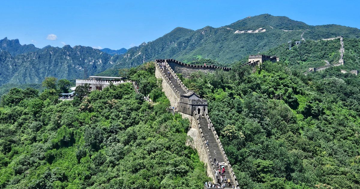 Aerial view of the Mutianyu Great Wall winding through green mountains