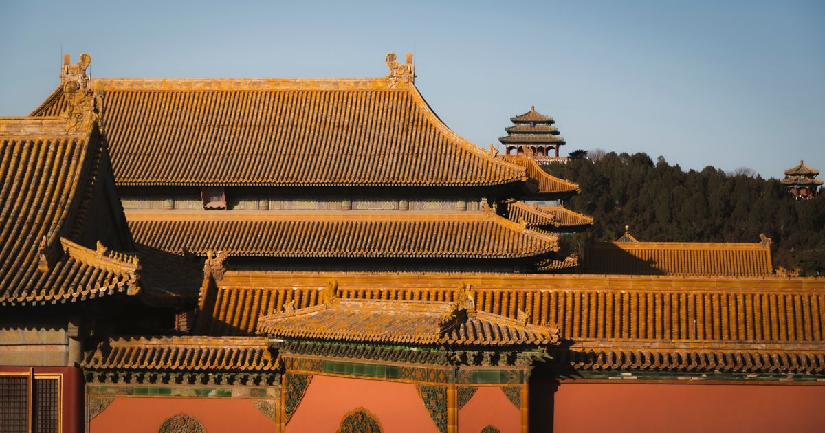 Golden palace roofs of the Forbidden City at sunset