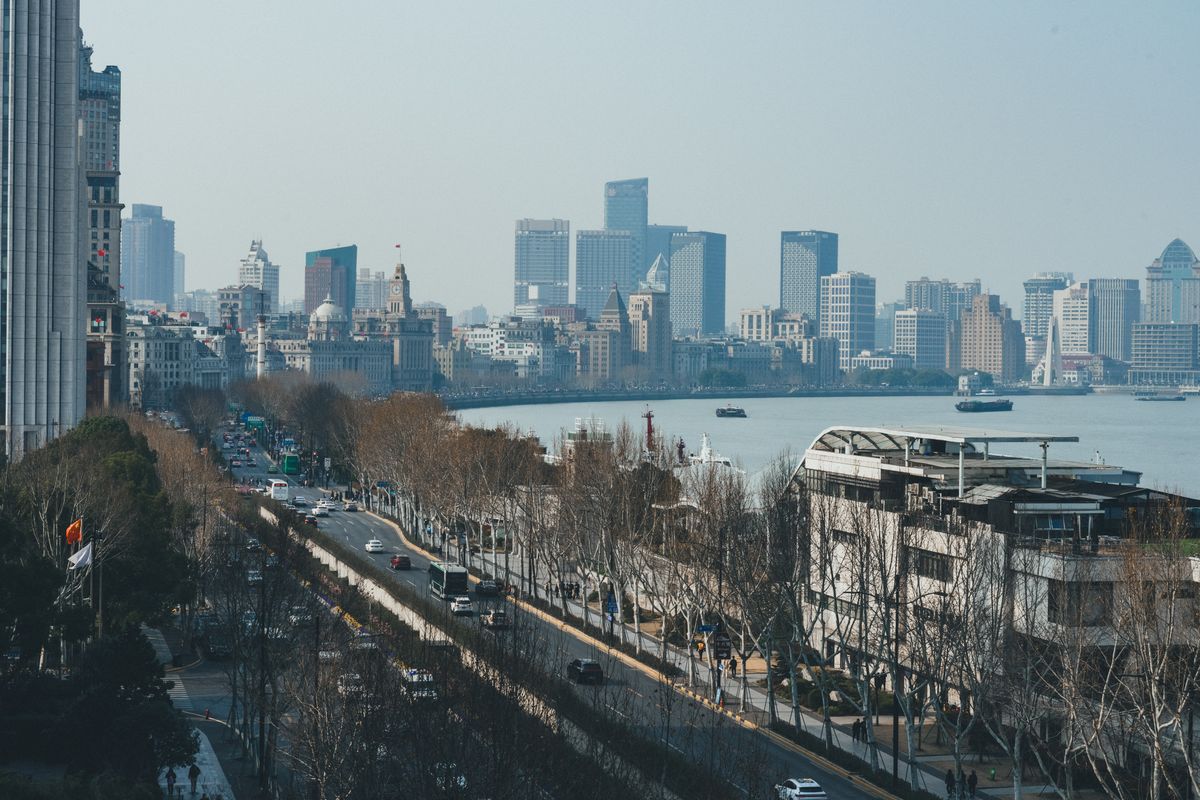 Daytime view along the Bund waterfront promenade and the Huangpu River