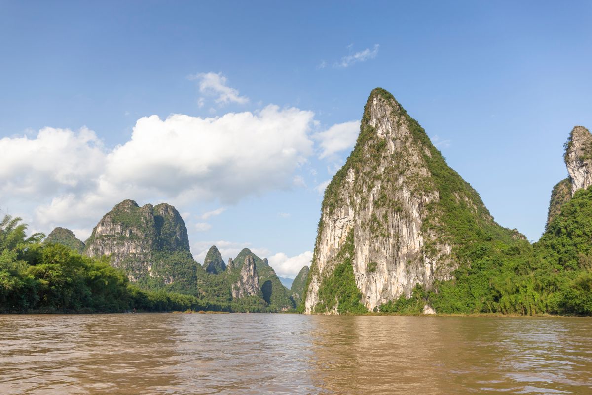 Limestone karst peaks rising straight from the green water of the Li River