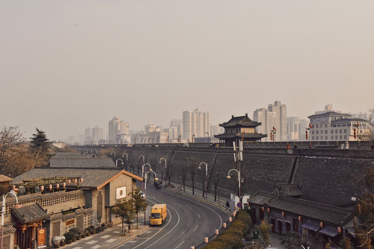 The massive grey rampart of the Xi'an City Wall beside the modern city