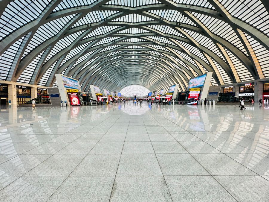 Travellers and a CRH train at a covered China Railway platform