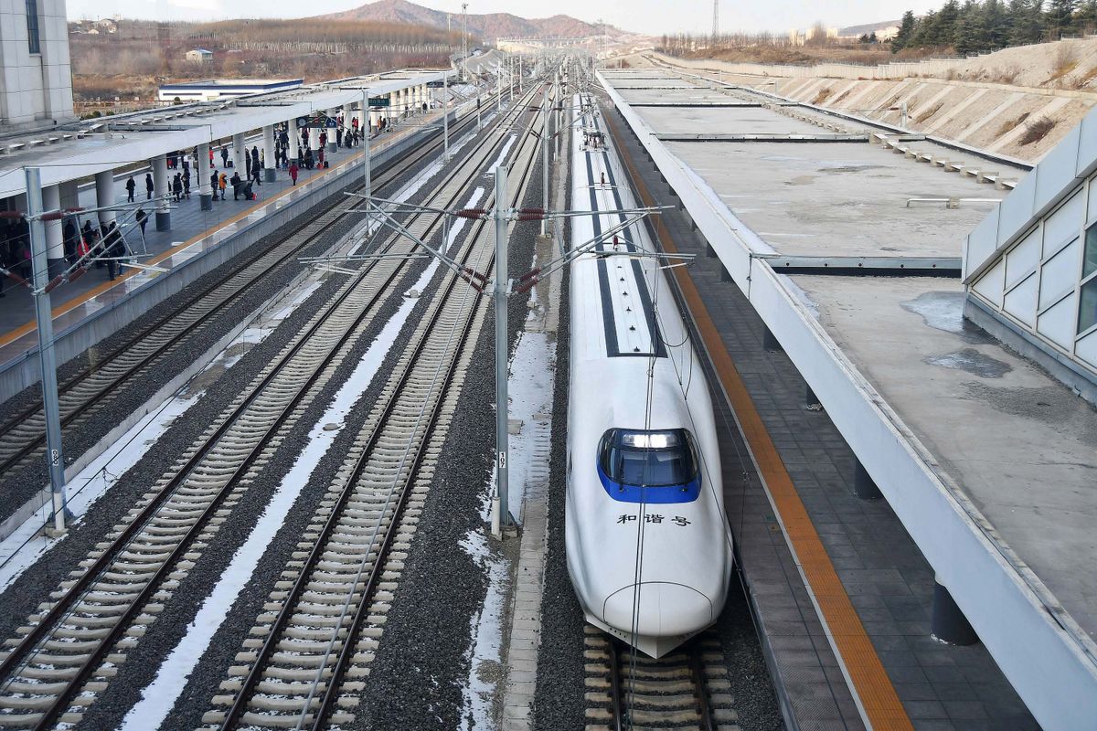 A Chinese high-speed train waiting at a station platform
