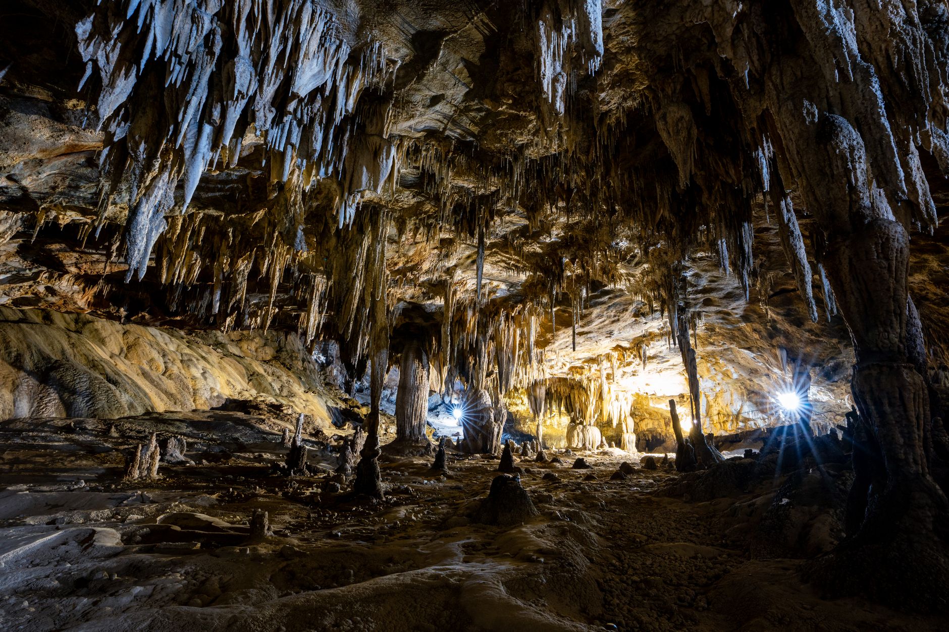 Grand illuminated stalactite chamber inside Huanglong Cave