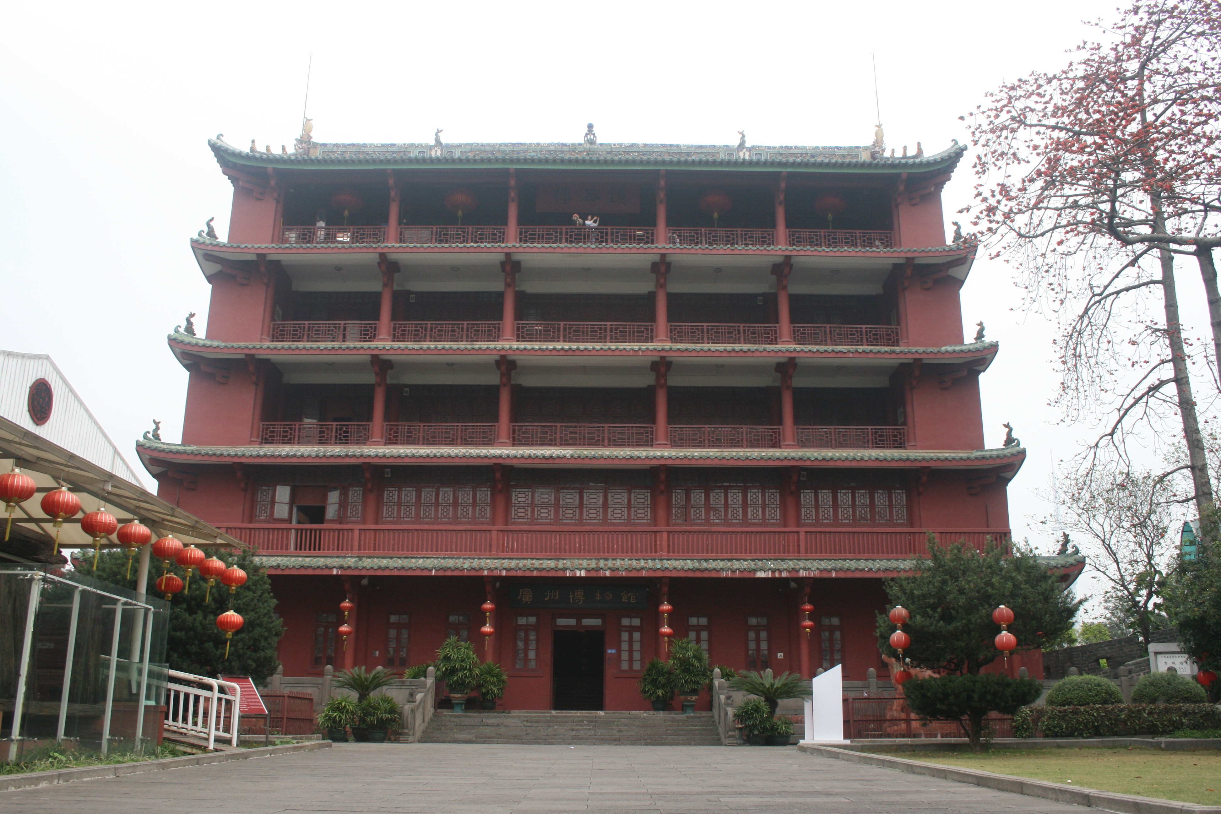 The red five-storey Zhenhai Tower standing on a hill in Yuexiu Park