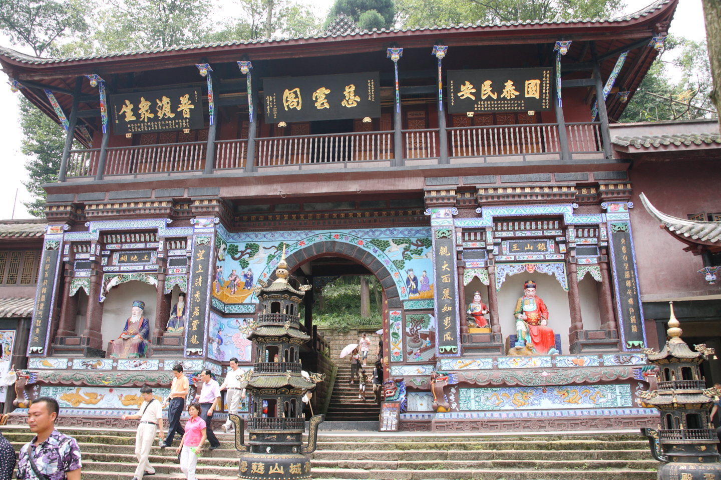 Misty forest trail and traditional structures on Mount Qingcheng