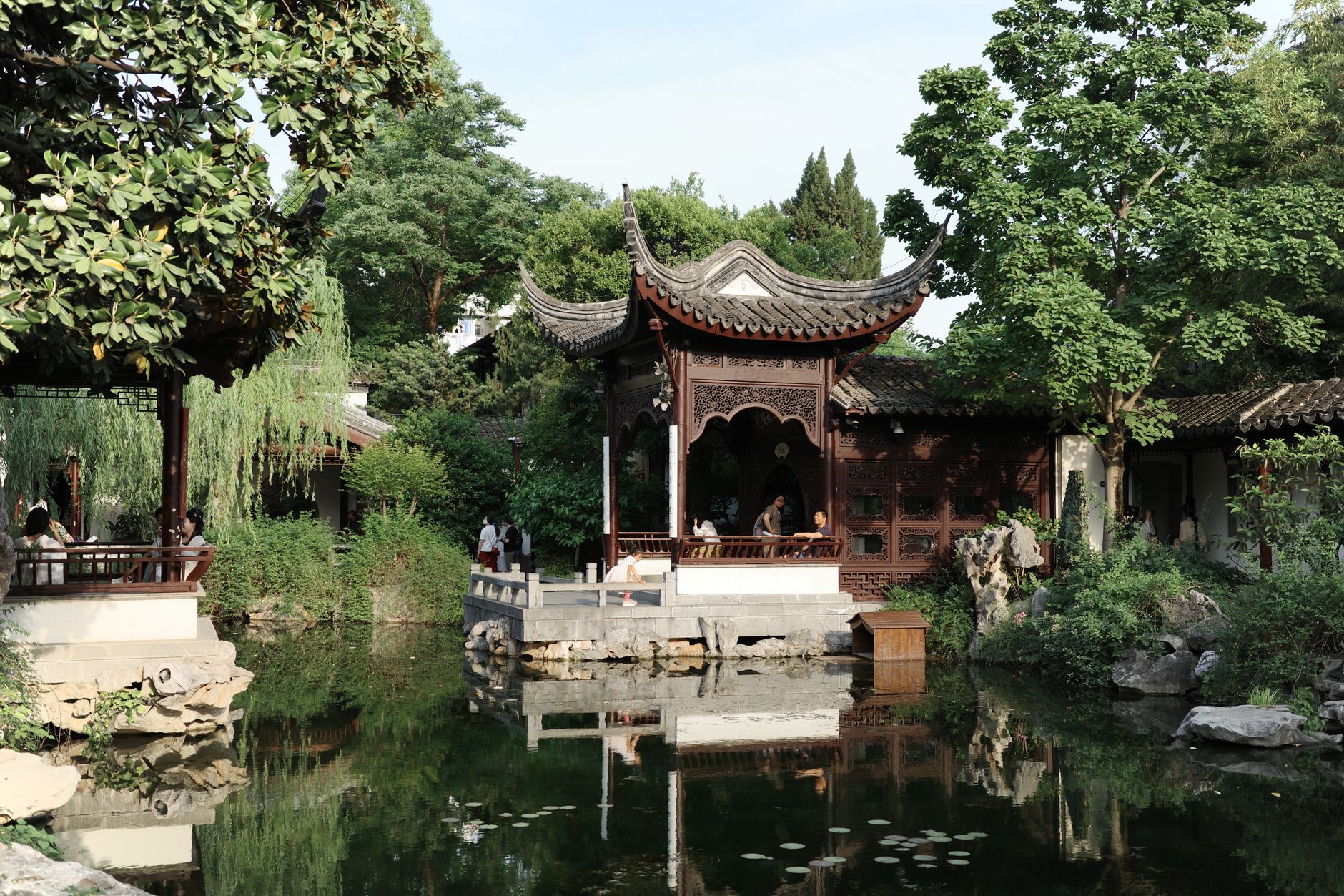 Garden pavilion reflected in a still pond