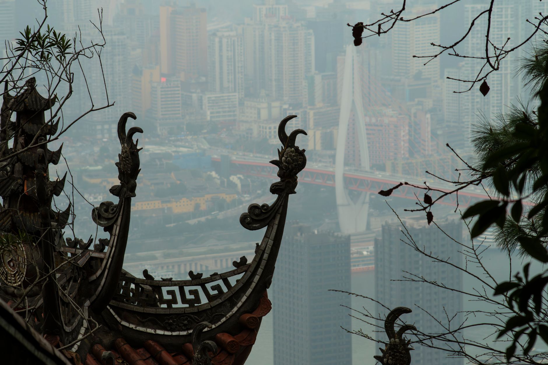 Temple eaves framing the Chongqing skyline at Ciqikou