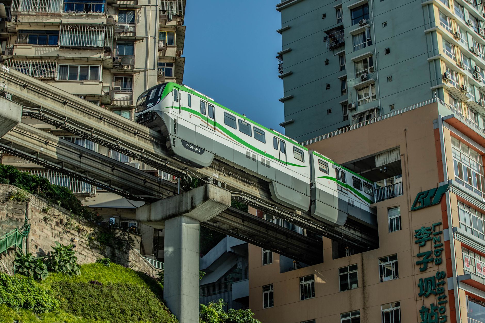 Monorail train emerging from the residential tower at Liziba