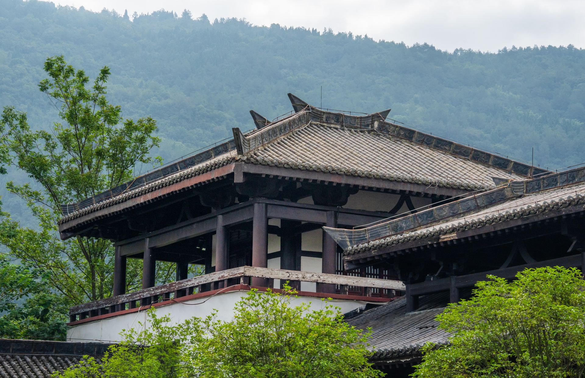 Traditional pavilion amid the green peaks of Qiyun Mountain