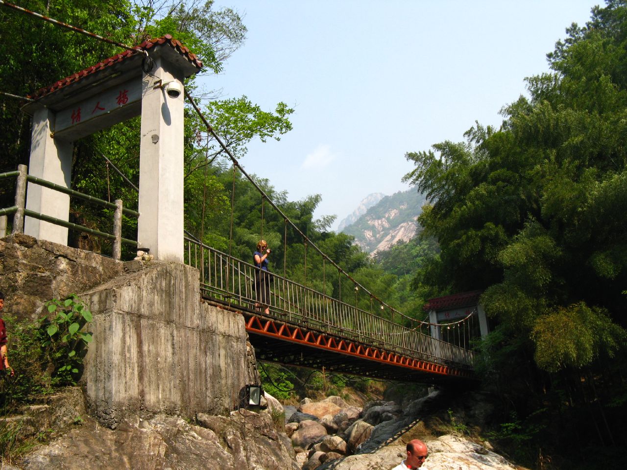 Footbridge and stream framed by green hills in Emerald Valley