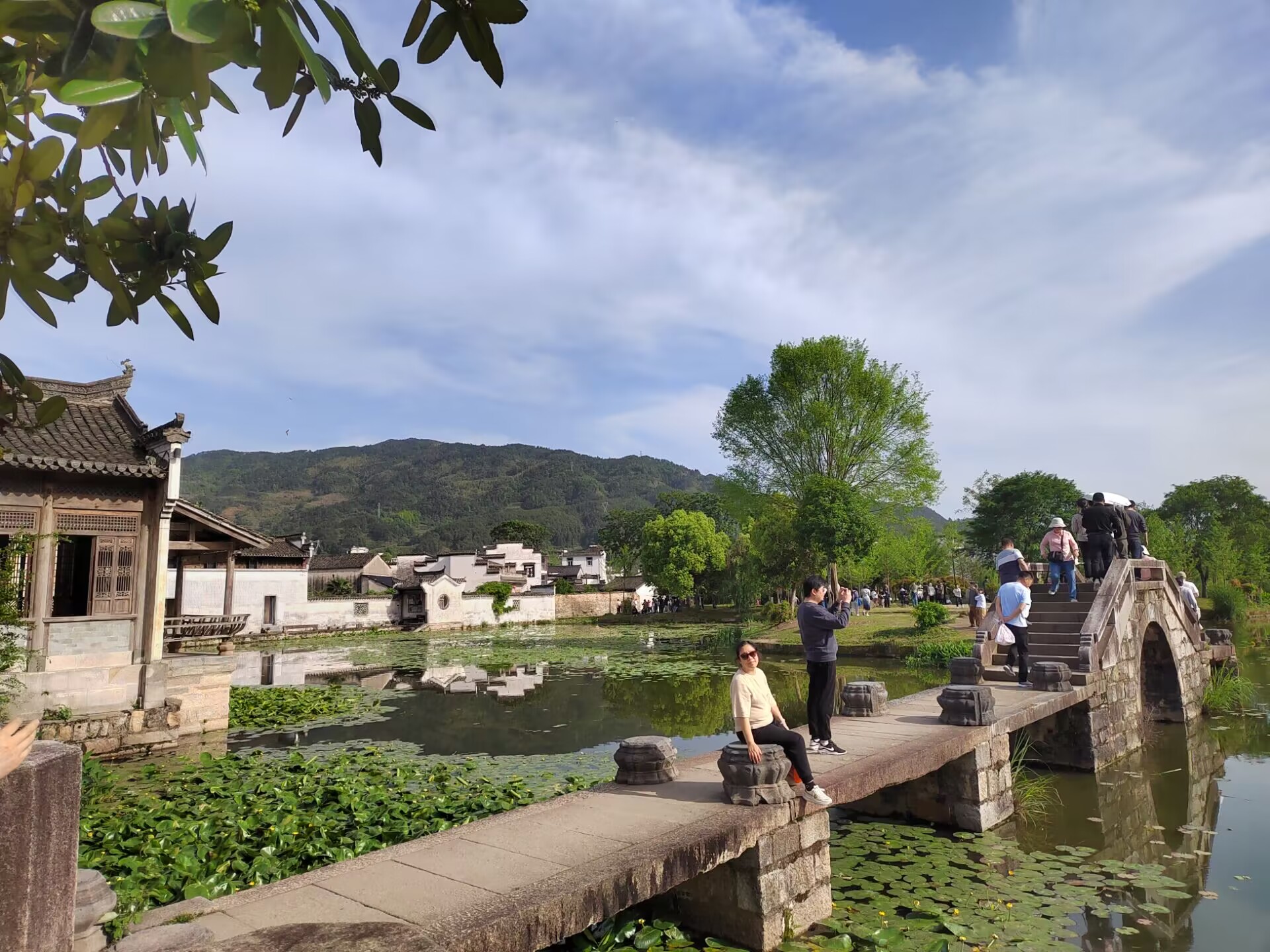 Chengkan village pond, bridge and Huizhou houses below the hills