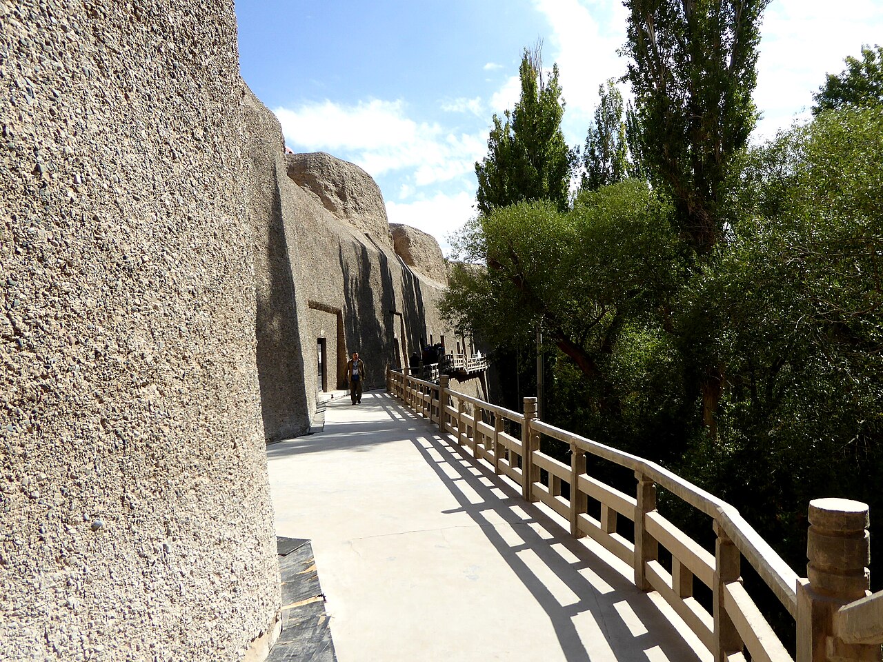 The cliff face of the Western Thousand Buddha Caves above the Dang River
