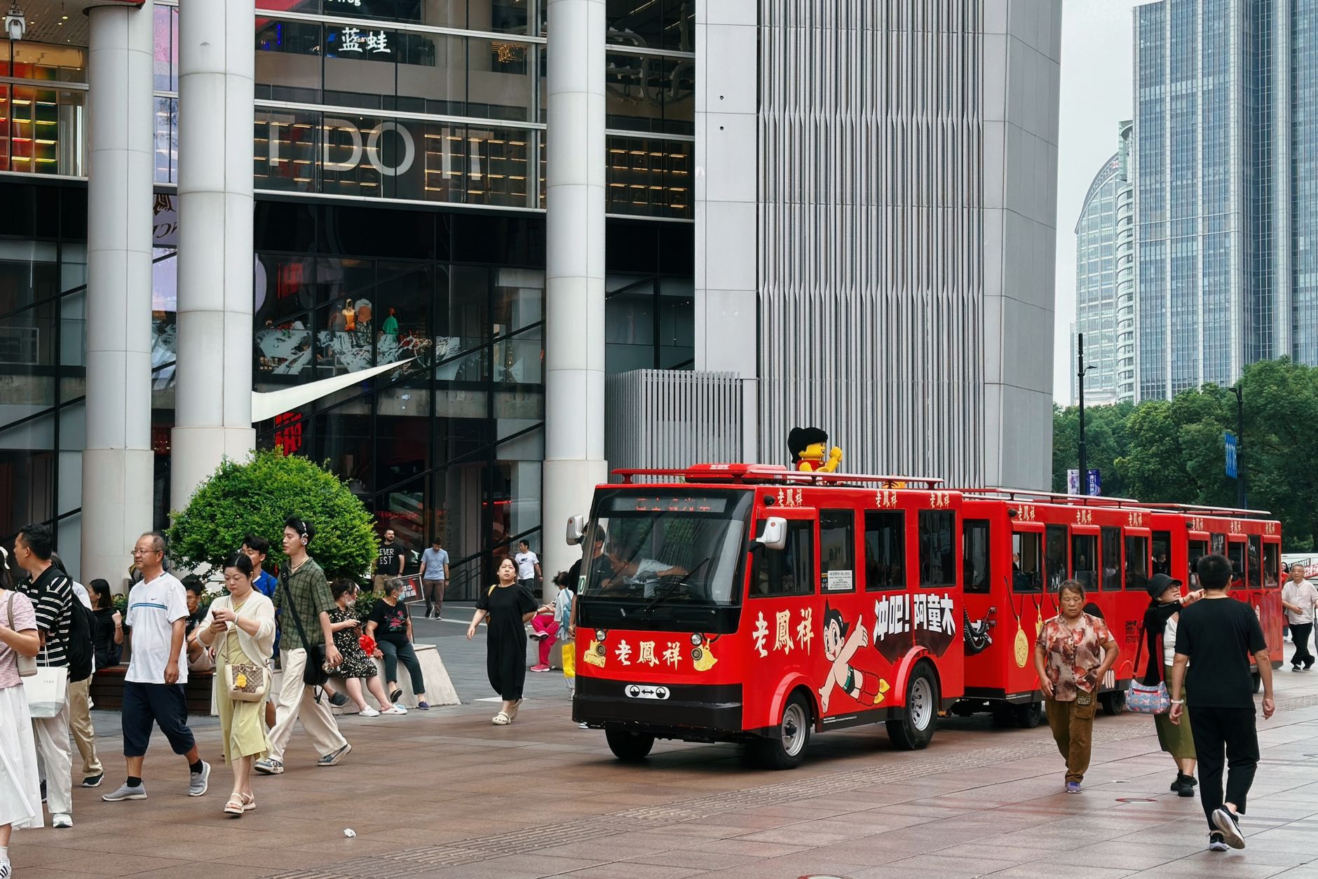 Street scene with tourist trolley and shoppers