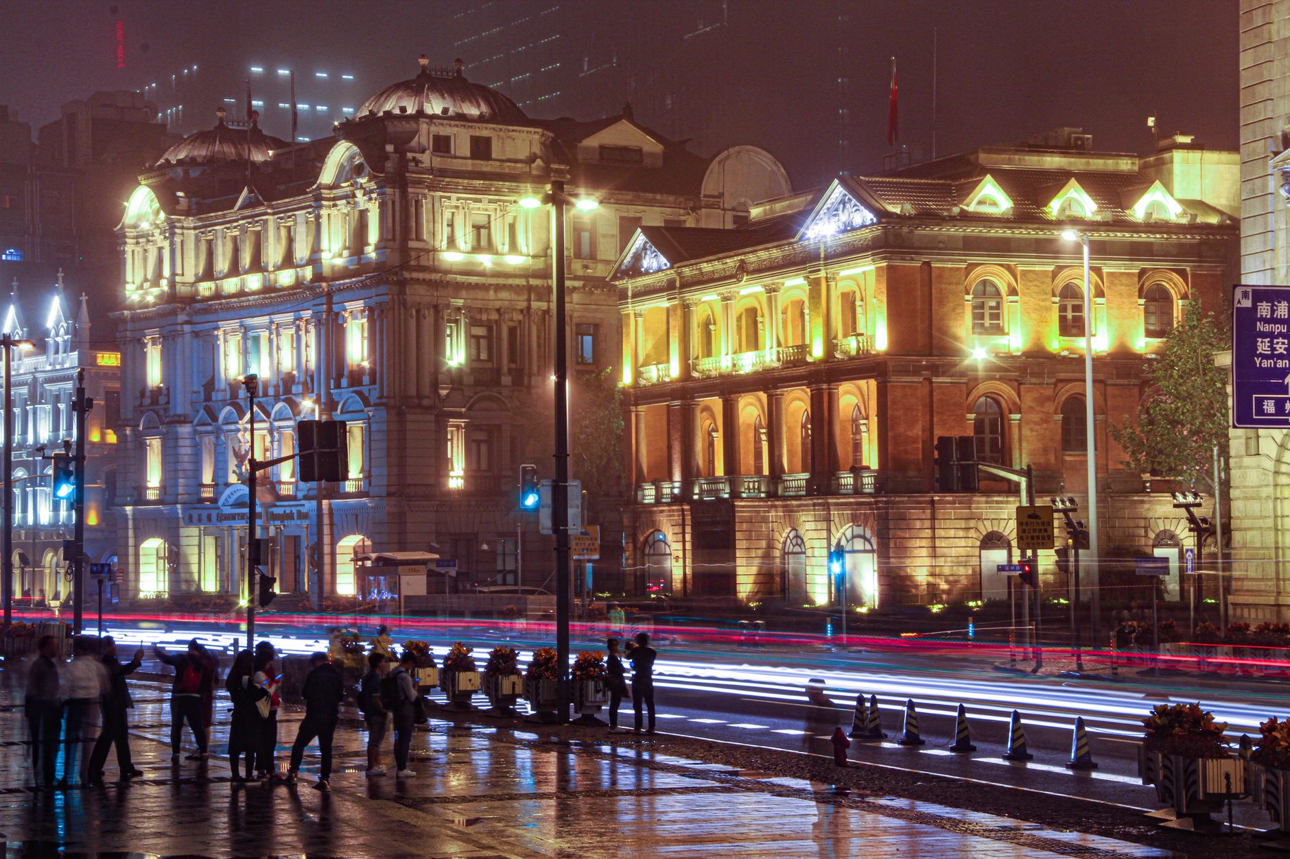 Illuminated historic buildings along the street at night