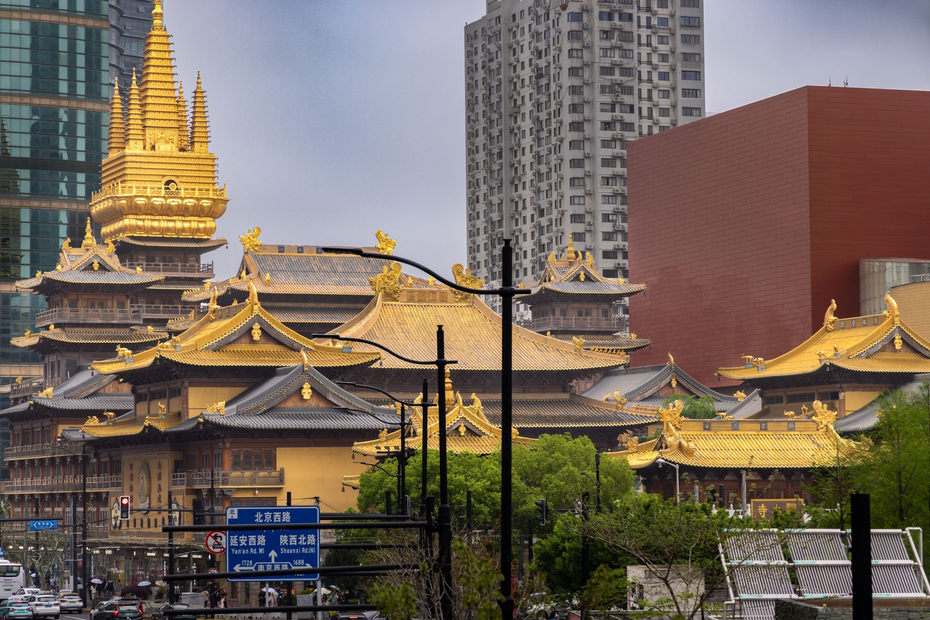 Golden temple rooftops framed by modern towers