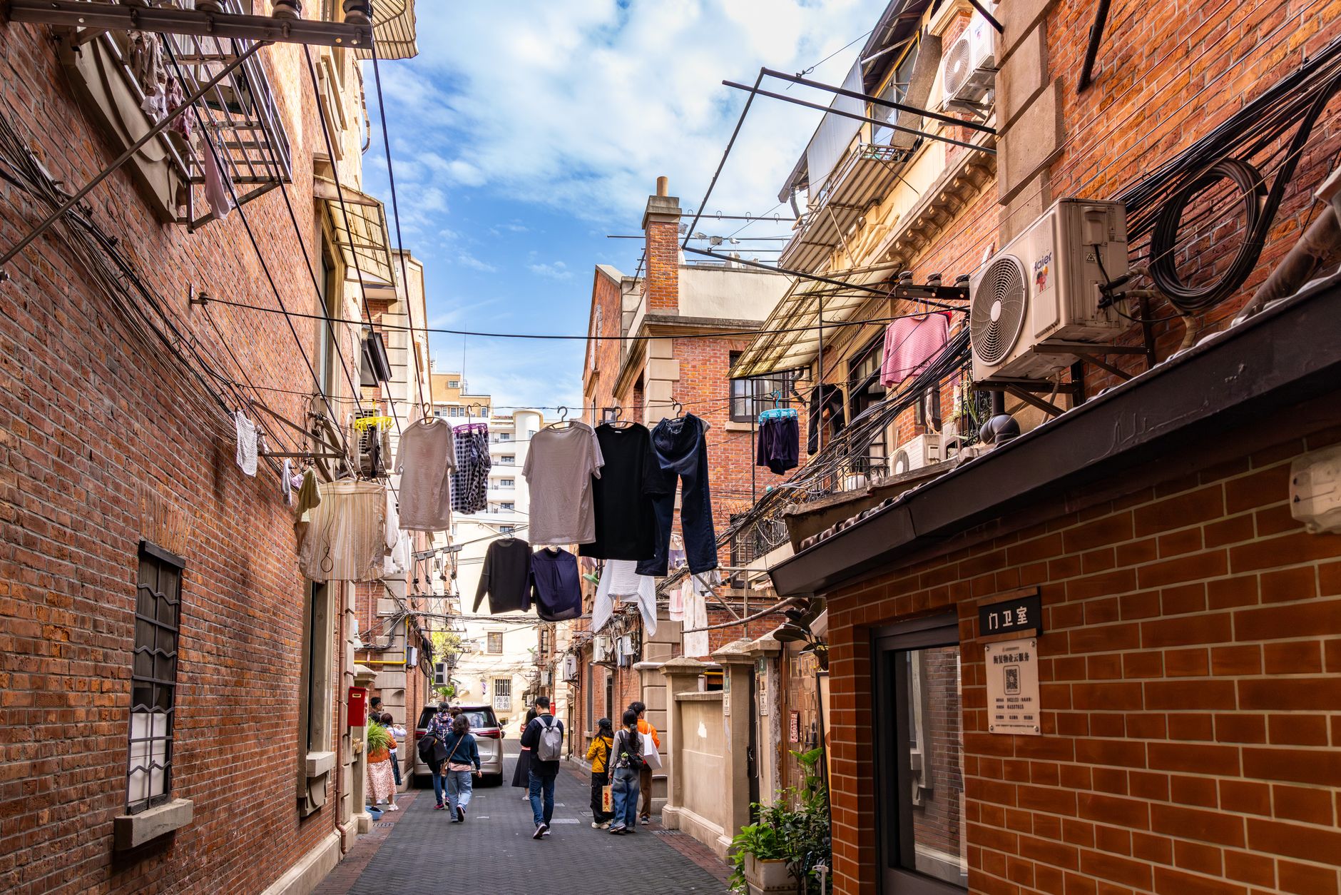 Old brick lane with shops and pedestrians