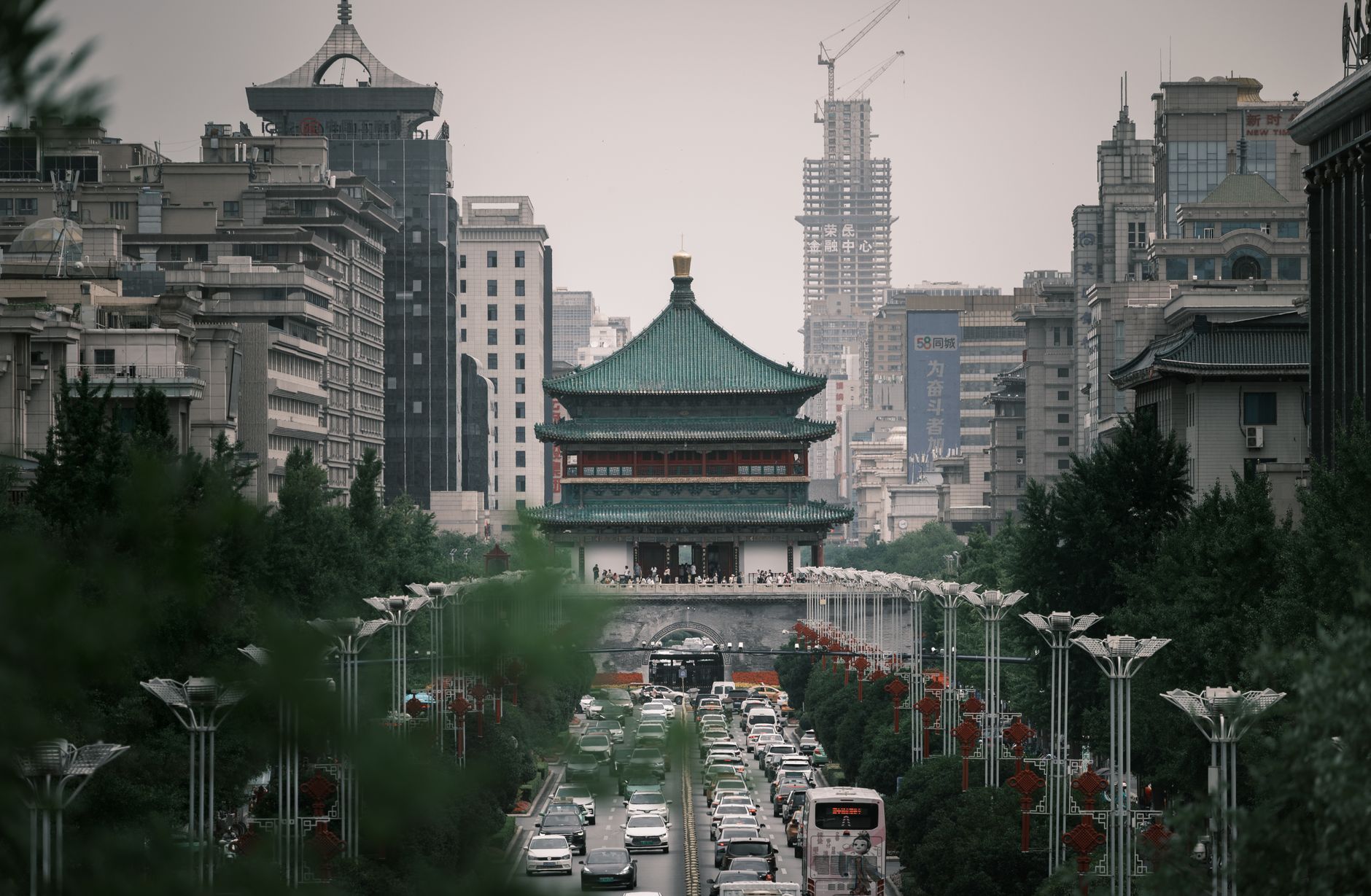 The illuminated tower seen across the surrounding plaza