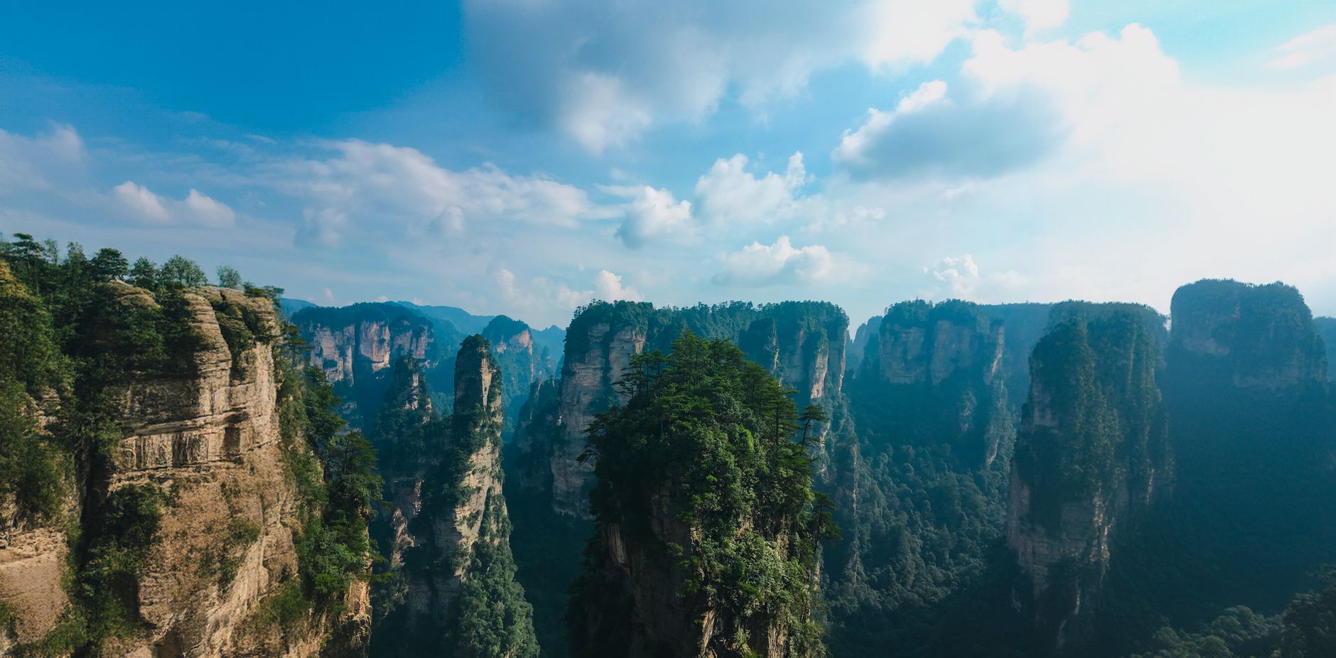 Towering sandstone pillars of Yuanjiajie under a blue sky