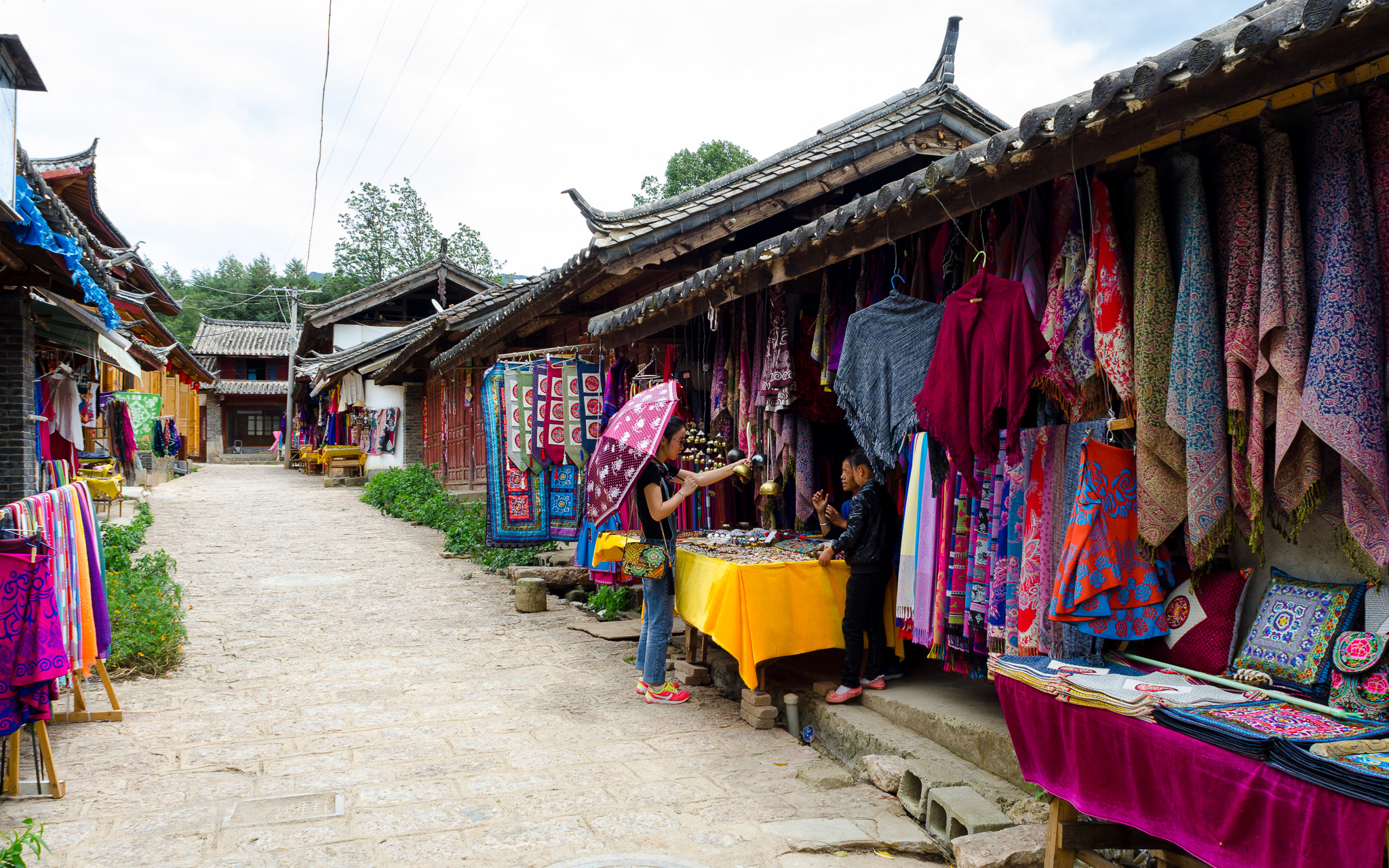 Baisha Old Town main street with a Naxi handicraft stall
