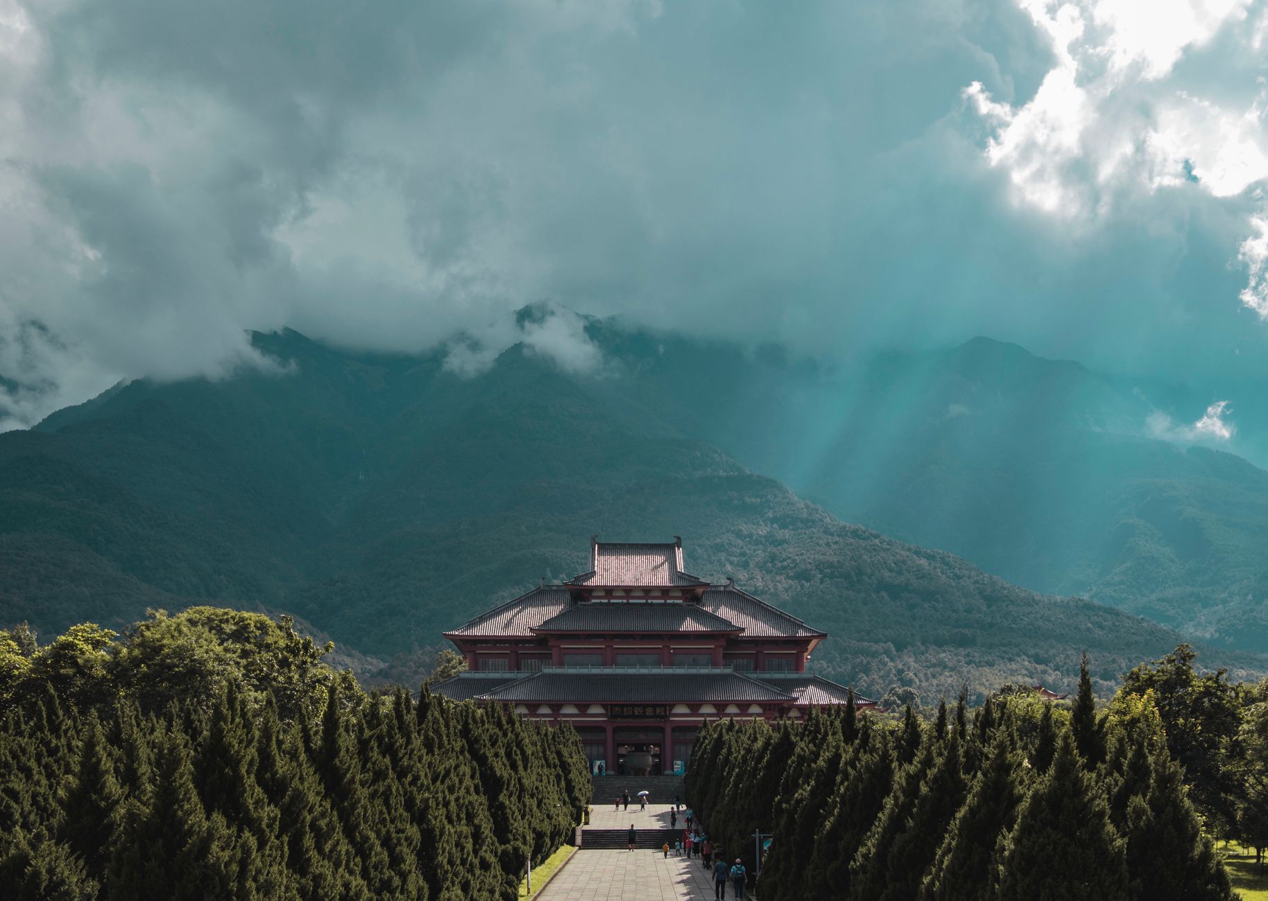 A temple hall below misty green mountains near Chengdu