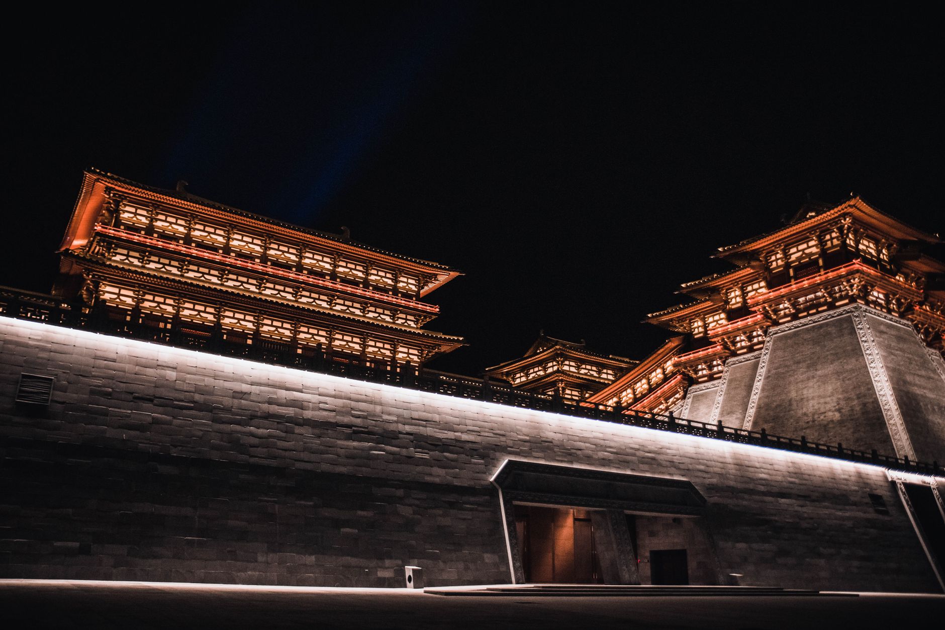 Illuminated gate towers of Xi'an's old city wall glowing at night