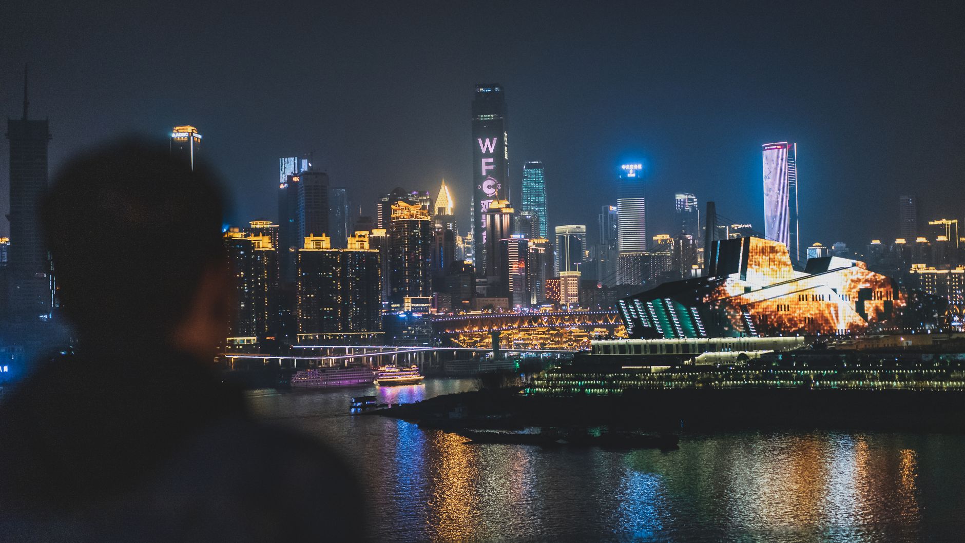 Chongqing skyline glowing at night above the Yangtze River