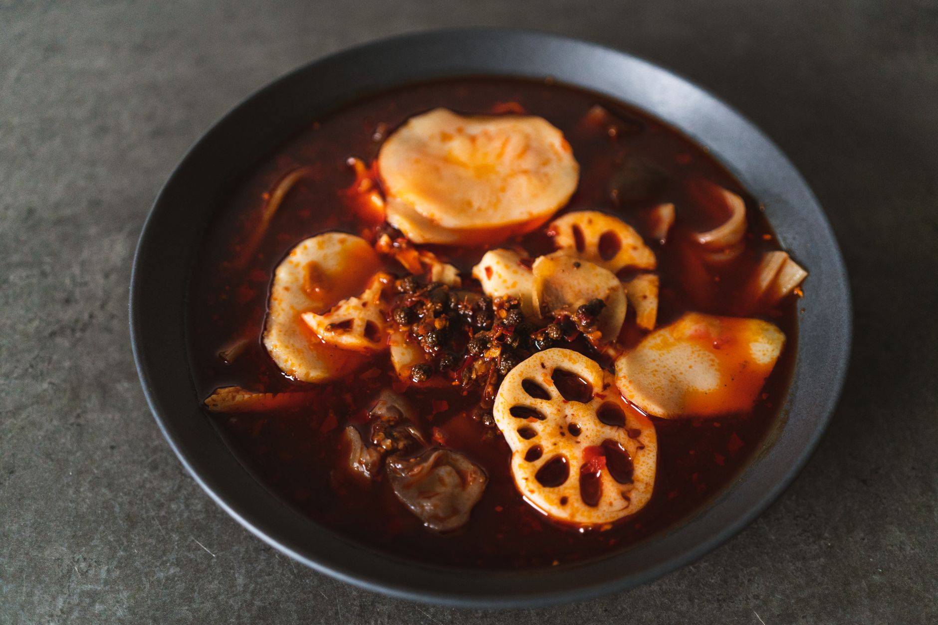 A pot of Chongqing málà hotpot with lotus root and chilli oil