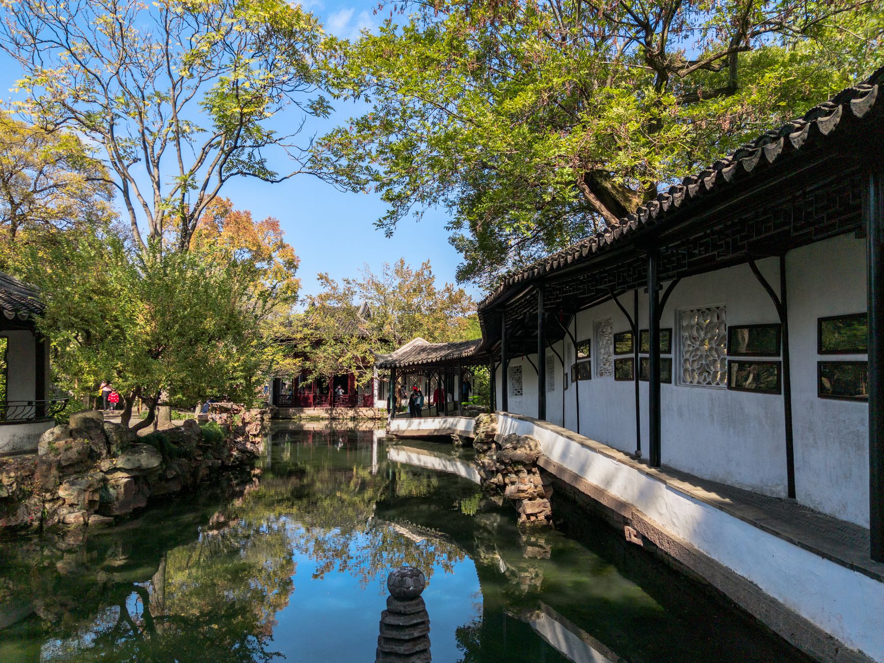 A covered walkway and reflecting pond in a classical Suzhou garden