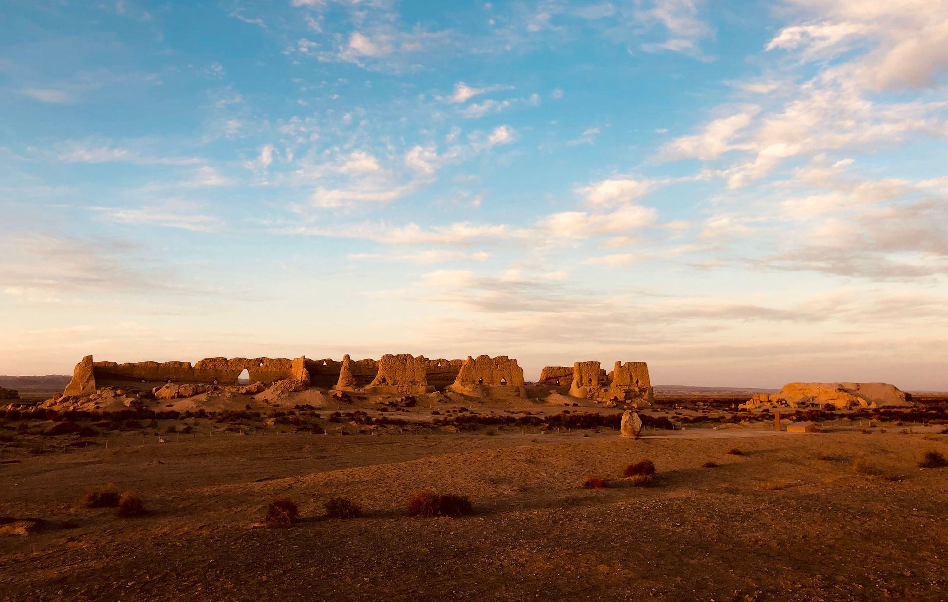 Ancient Silk Road fortress ruins in the Gobi at golden hour