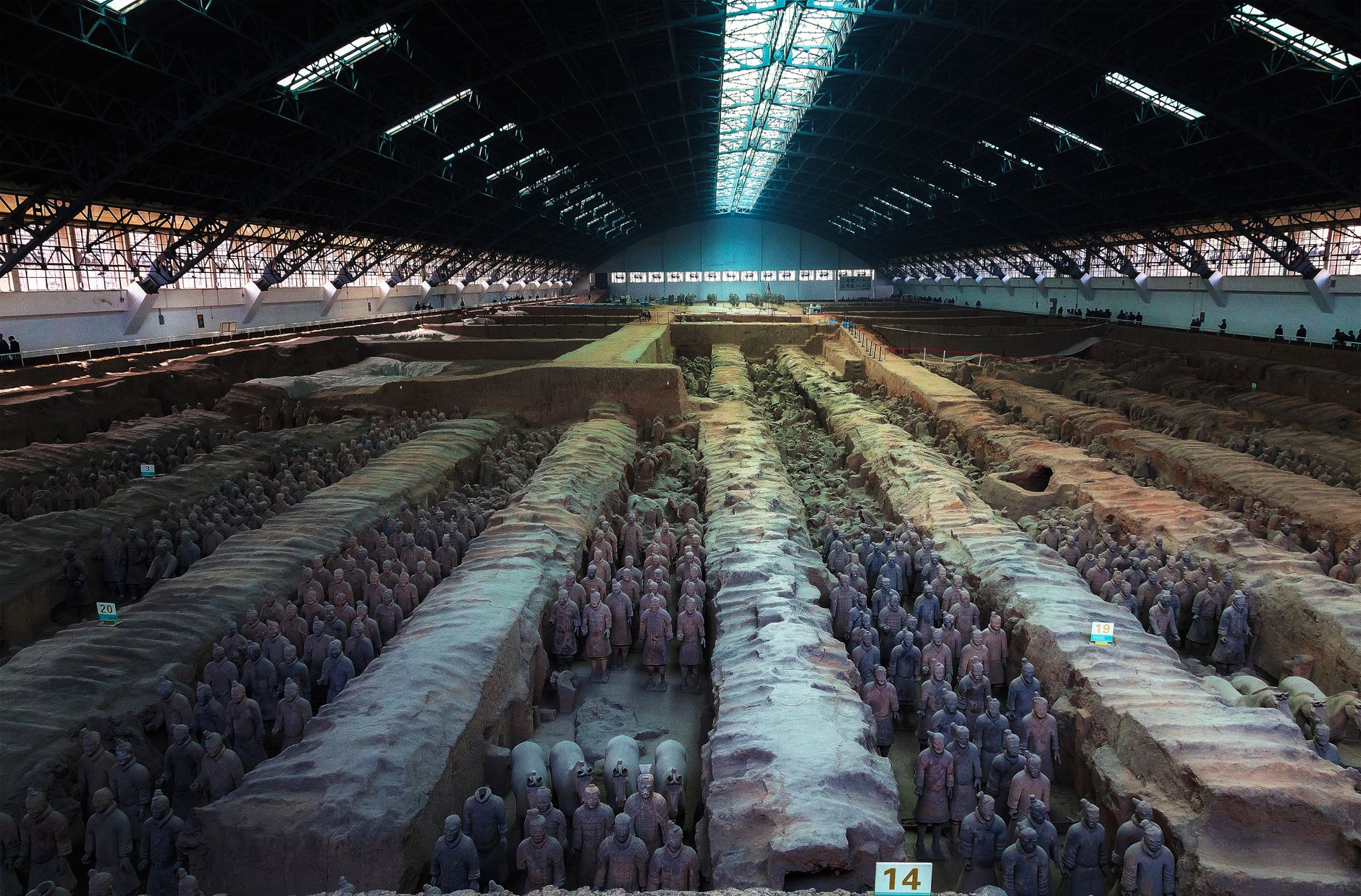 Rows of life-sized Terracotta Army warriors in the excavation pits at Xi'an