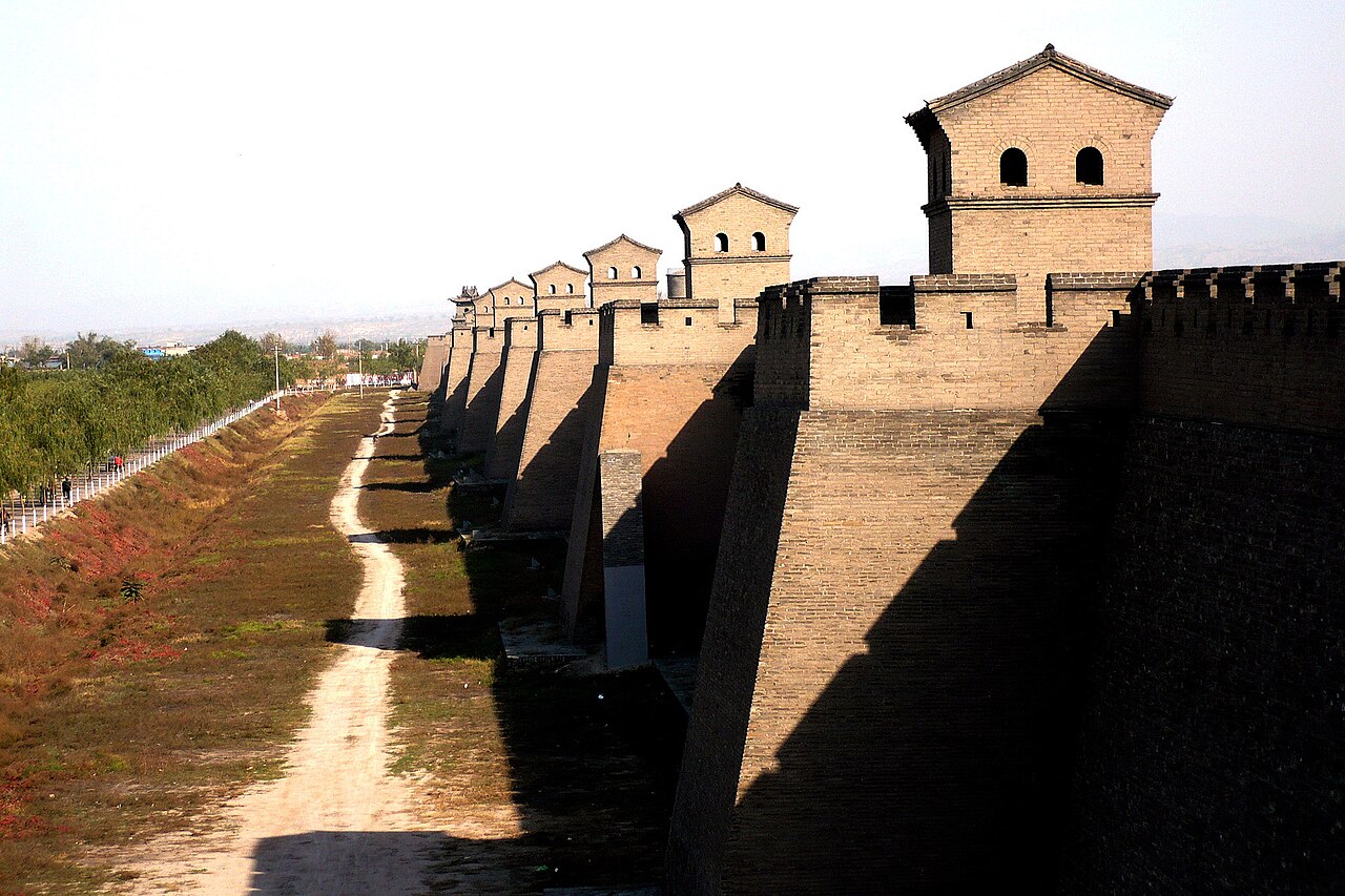 Pingyao's grey-brick rampart with a row of watchtowers above the dry moat