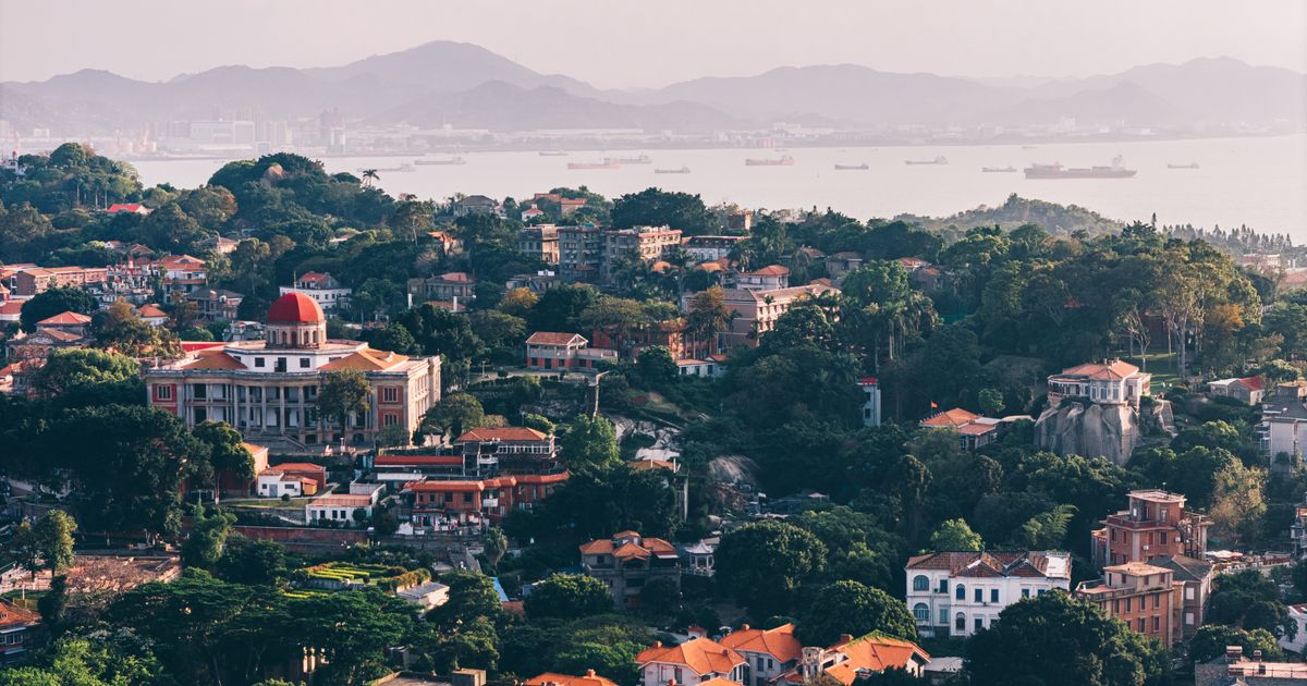 Aerial view of Gulangyu Island's red-roofed villas among the greenery