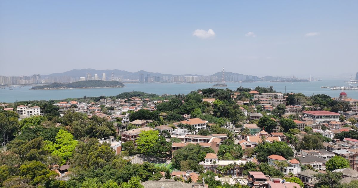 Gulangyu's red-tiled villas with the Xiamen skyline across the water