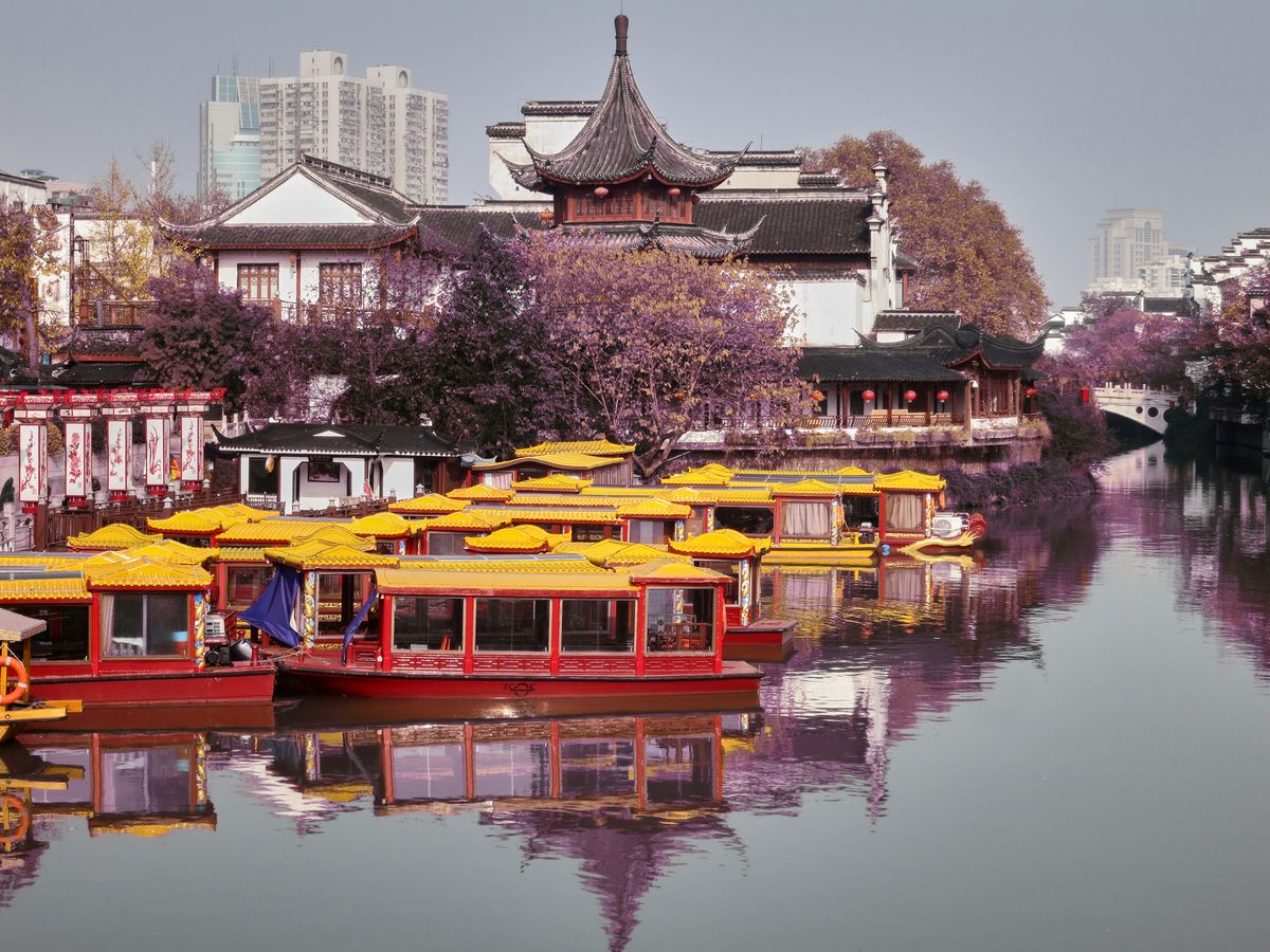 Dragon boats and traditional buildings along the Qinhuai River