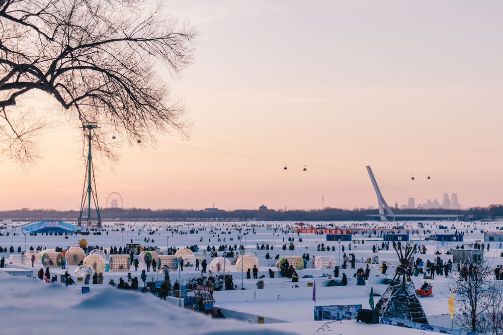 Ice fishing huts and cable cars over the frozen Songhua River at sunset