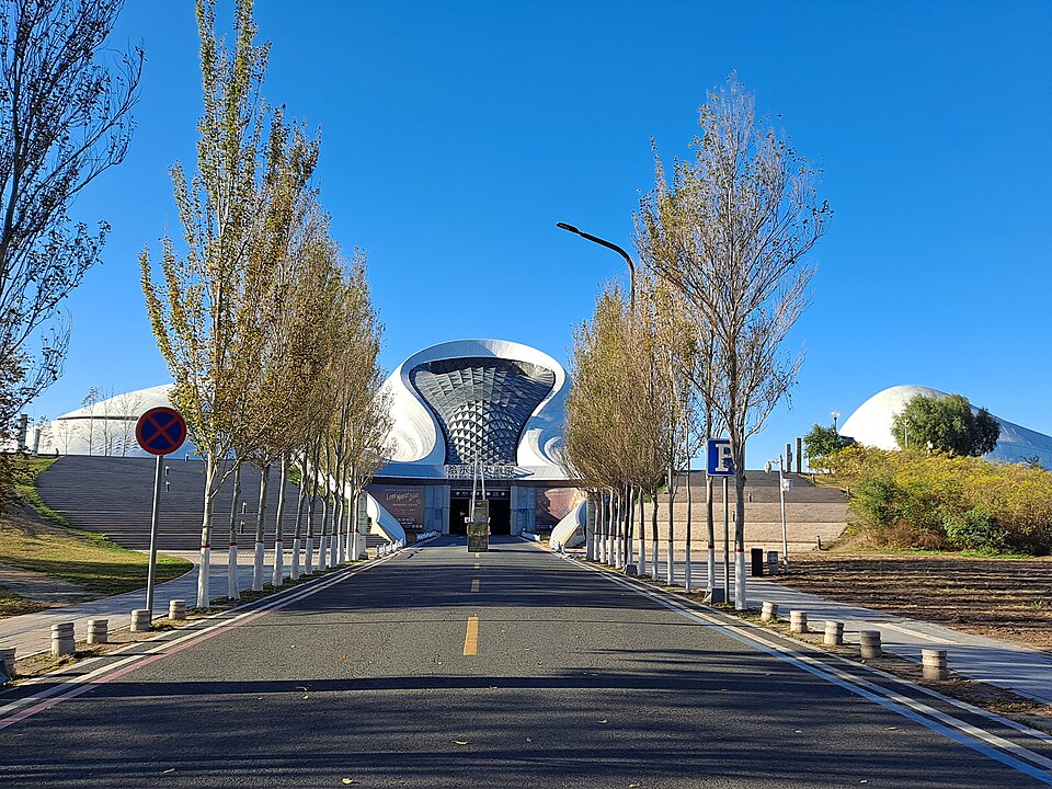 Approach to the Harbin Grand Theatre with its sweeping aluminium roofline