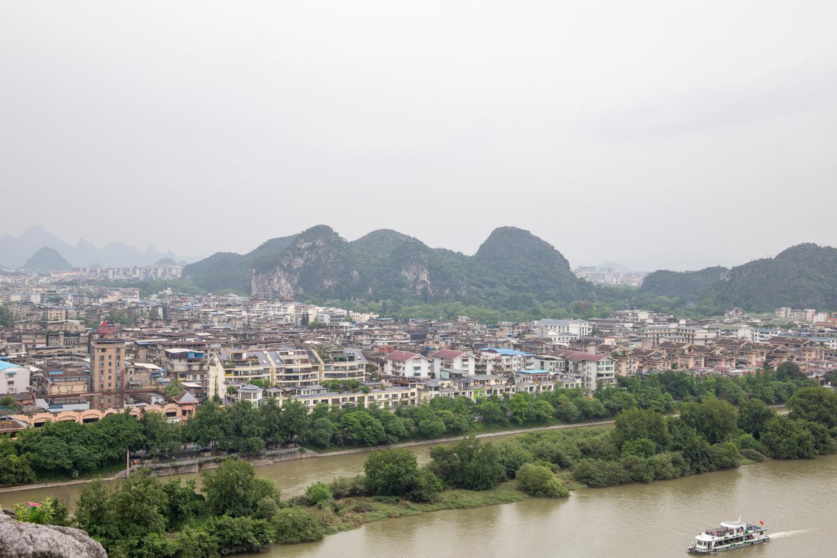 Karst peaks and a stone bridge over a lotus pond near Moon Hill