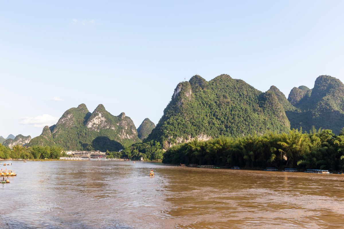 Bamboo raft drifting beneath the karst hills